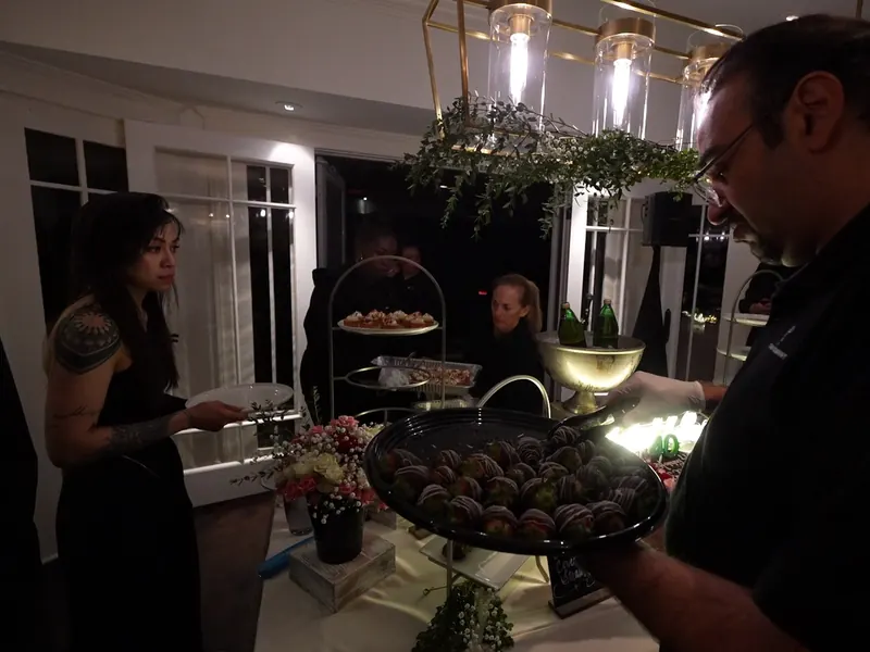 Server passing warm bites to guests at a Los Altos reception
