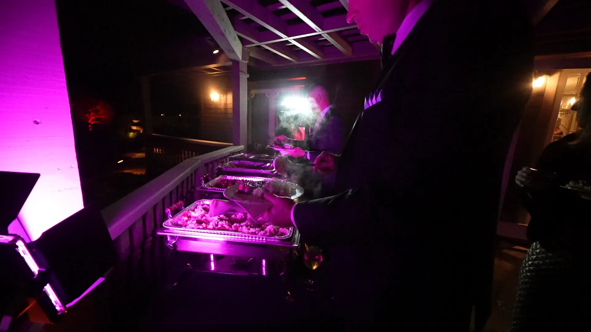 Evening buffet line lit and staffed for a downtown San Jose reception