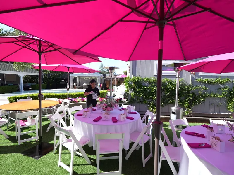 Buffet tables set among the garden seating at a Saratoga party