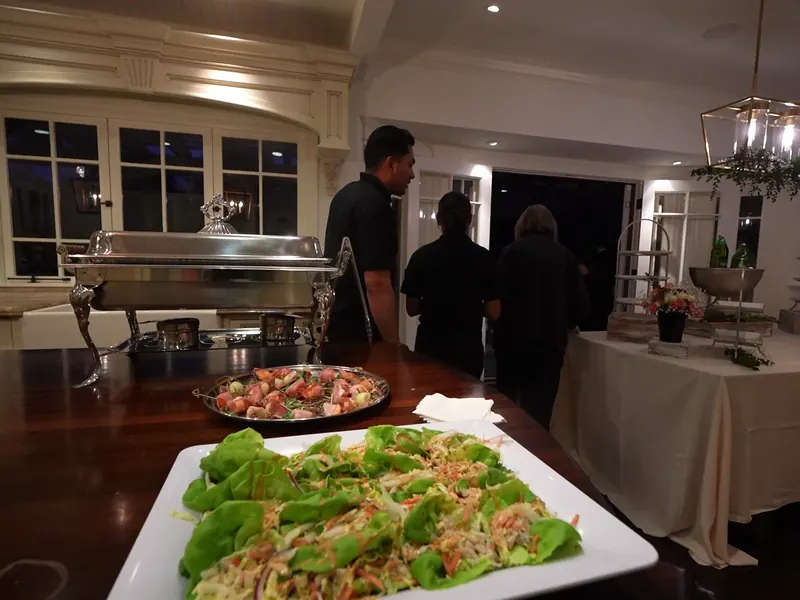 Fresh salad and entrée platters staged on a buffet for a Santa Clara lunch
