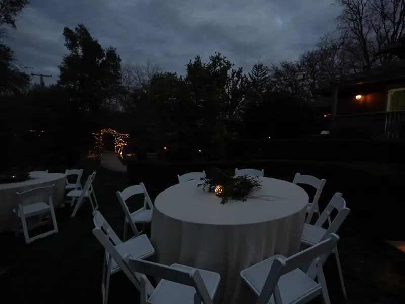 Round guest tables set for an evening dinner in Cupertino