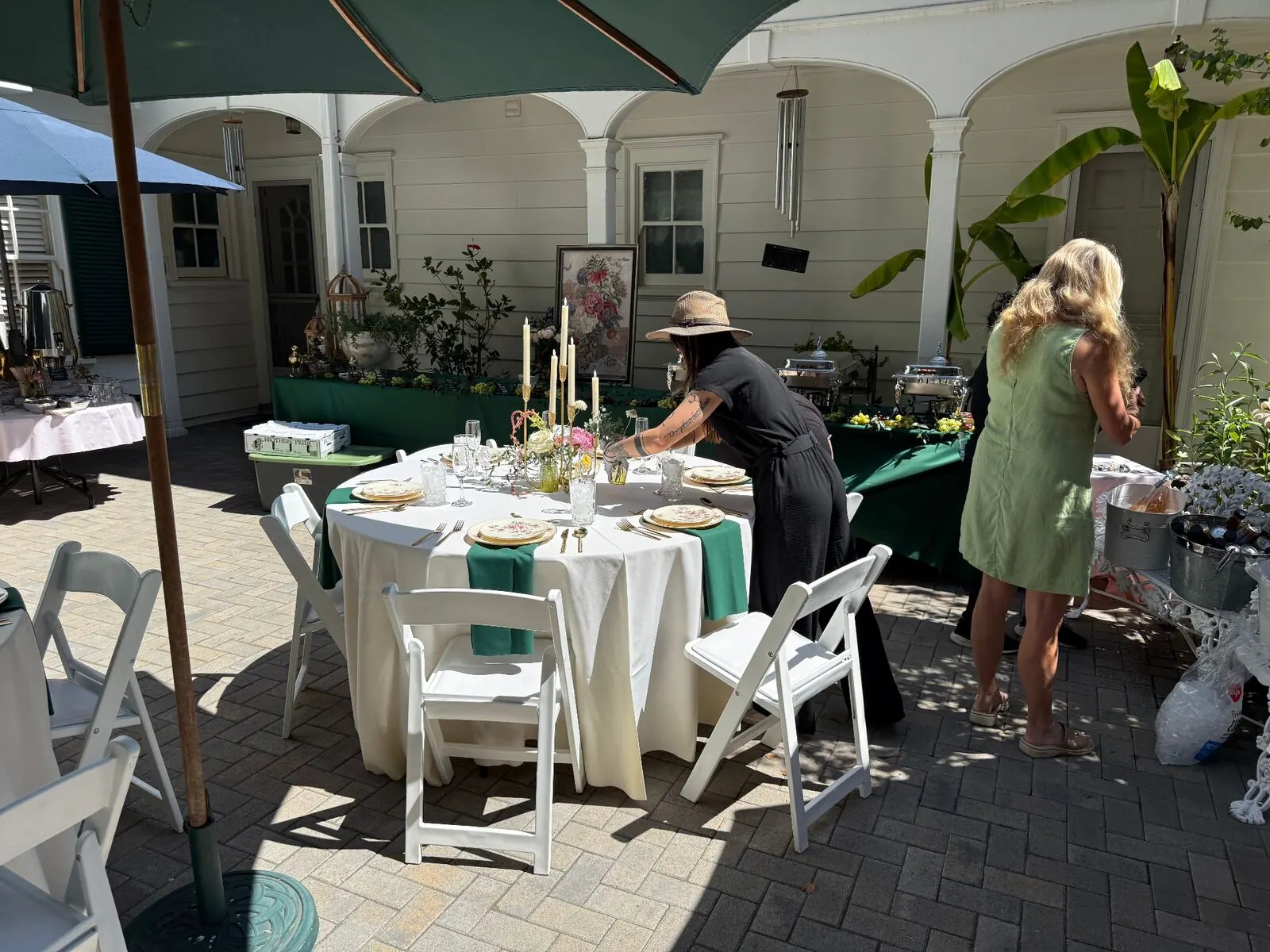 Outdoor courtyard dining setup with emerald linens and rented tables for a San Jose garden event by San Jose Catering Company