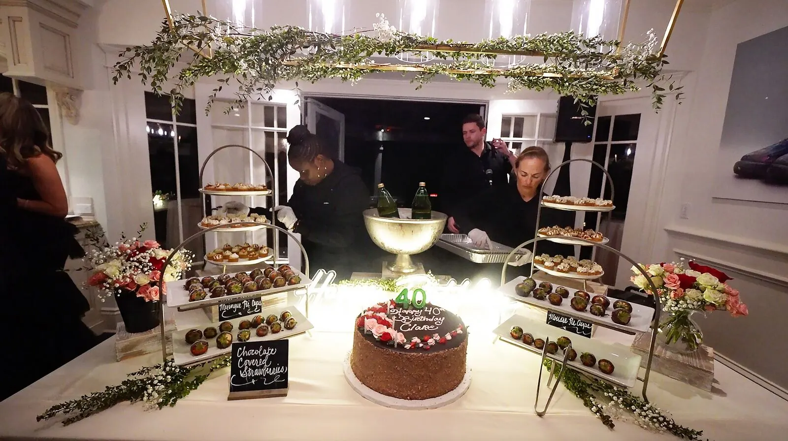 Tiered dessert stands of dipped strawberries, celebration cake and petite sweets softened with fresh stems — dessert styling for Santa Clara catering
